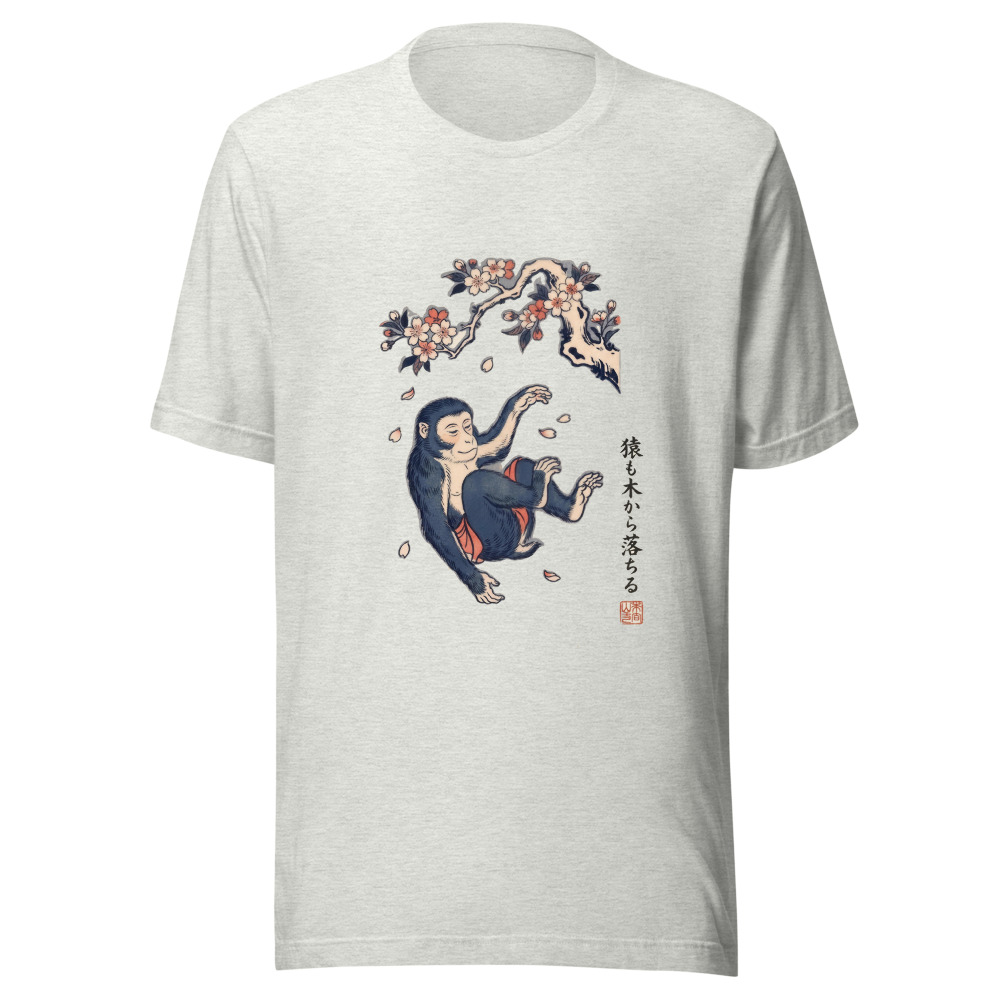 Even Monkeys Fall From Trees tee in ash, with the saying