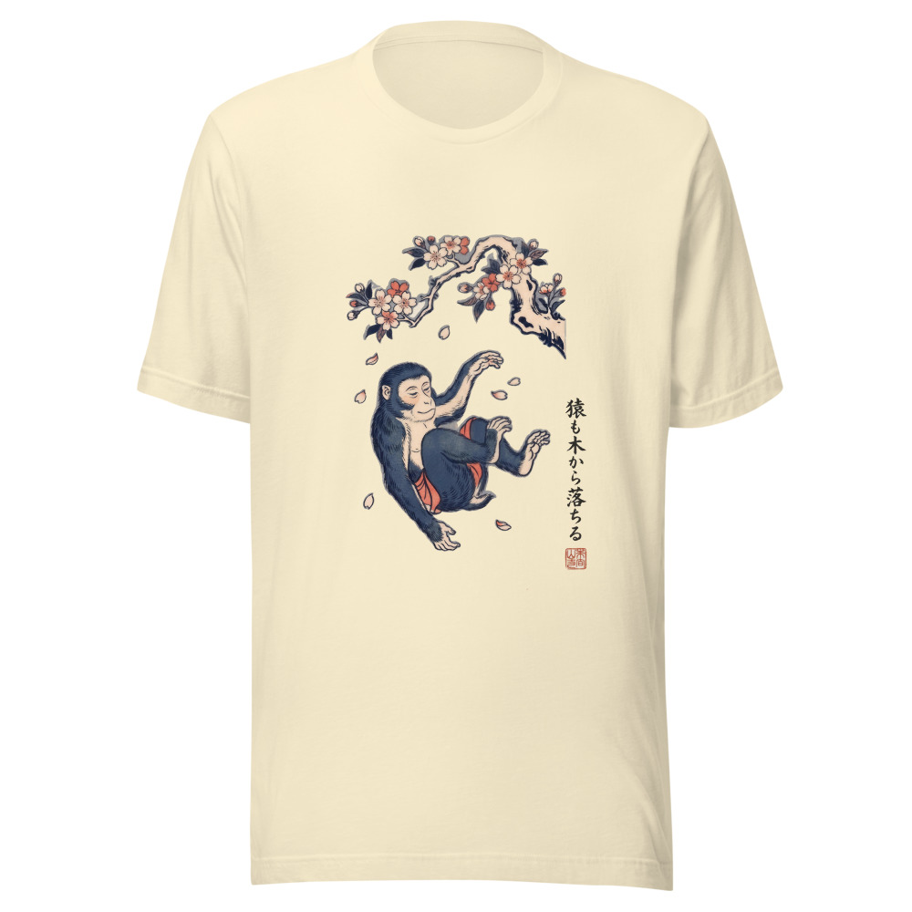 Even Monkeys Fall From Trees tee in natural, with the saying